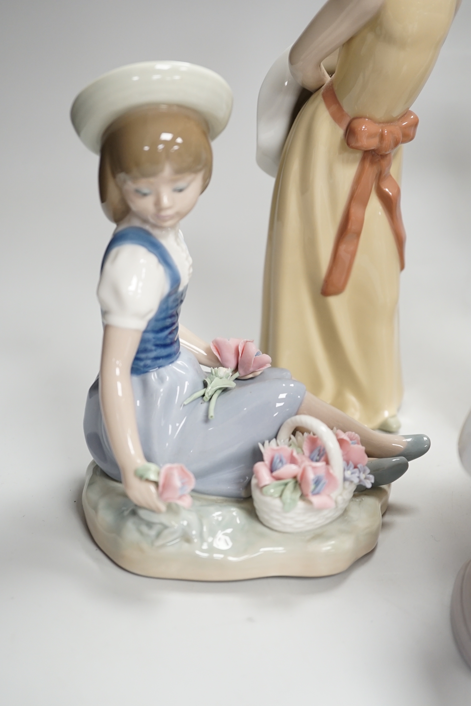 Six Lladro figures of girls, three with hats, one with a Teddy, two peasant girls with flowers and two Nao ducks, the largest 26cm high (8)